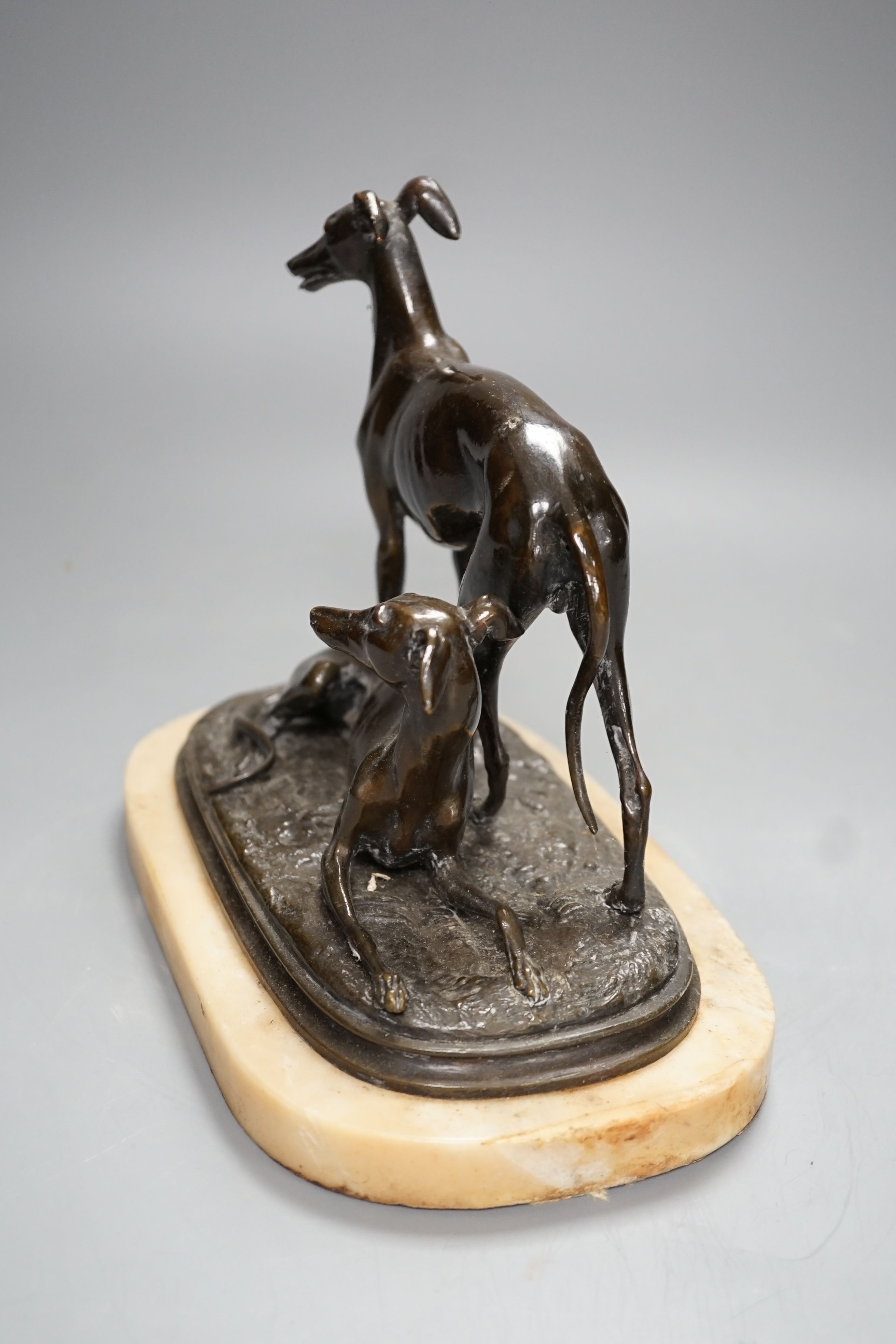 A bronze sculpture of a greyhounds on alabaster base, one seated and the other standing - 20cm high